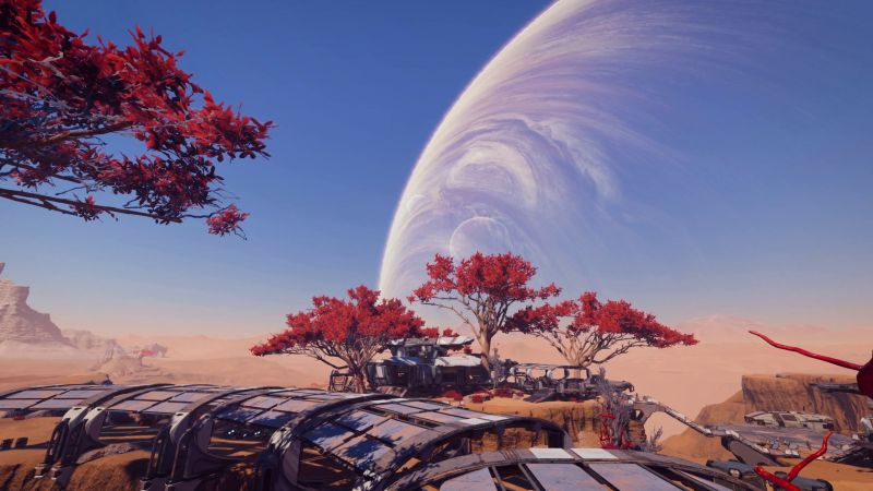 Колония на пустынное планете, где растут странные красные деревца - скриншот из Масс Эффект Андромеда